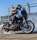 Man rides a Harley Davidson motorcycle outdoors on pavement with RWD V-Twin suspension installed