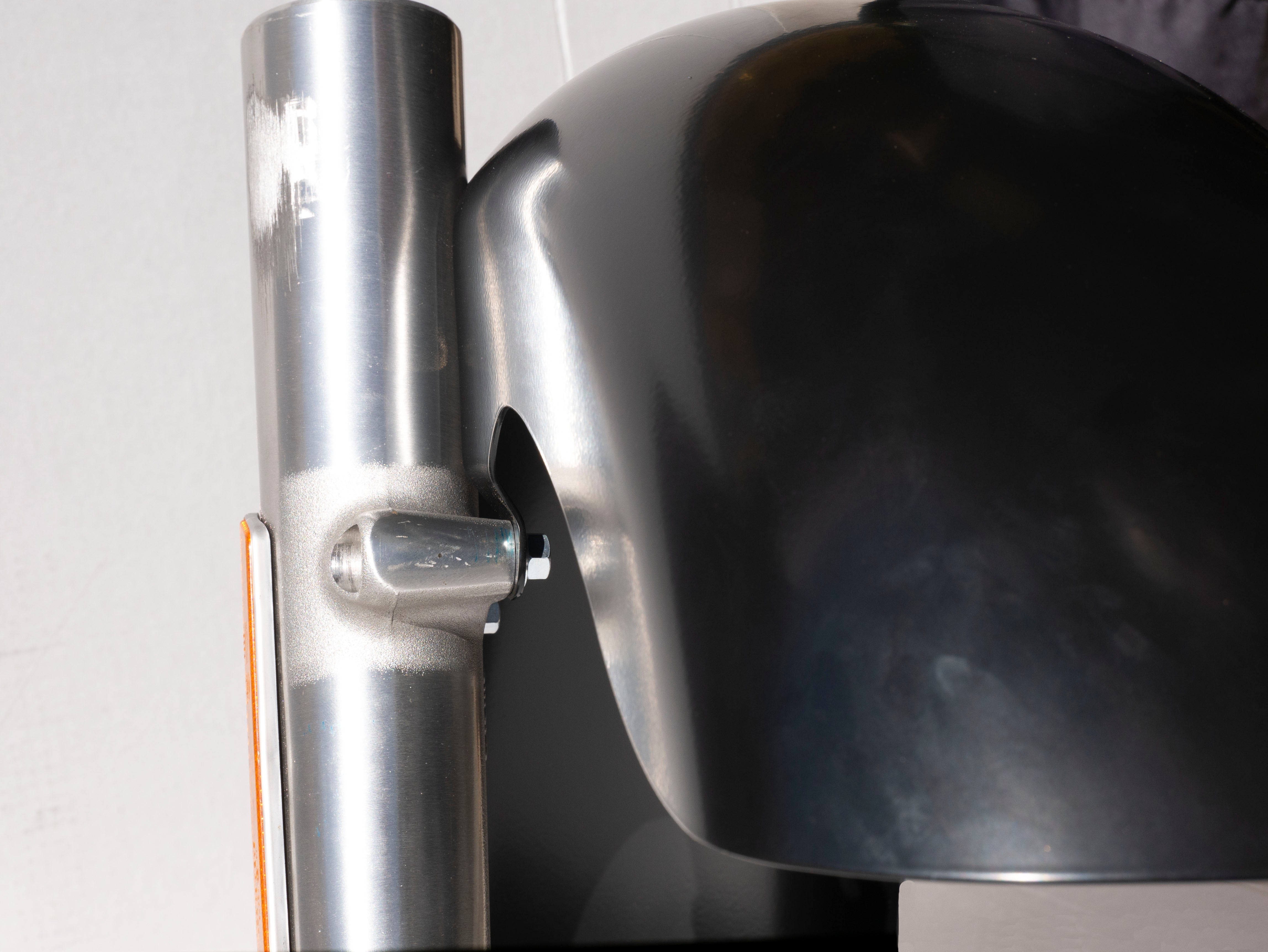 RWD V-Twin Easy 8 black 8-wide motorcycle front fender mounted on chrome fork close-up showing mounting bolt and amber reflector