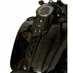 Close-up of Harley-Davidson Fat Boy dash and tank with four gold ARP stainless steel Bamco bolts on black glossy console and speedometer